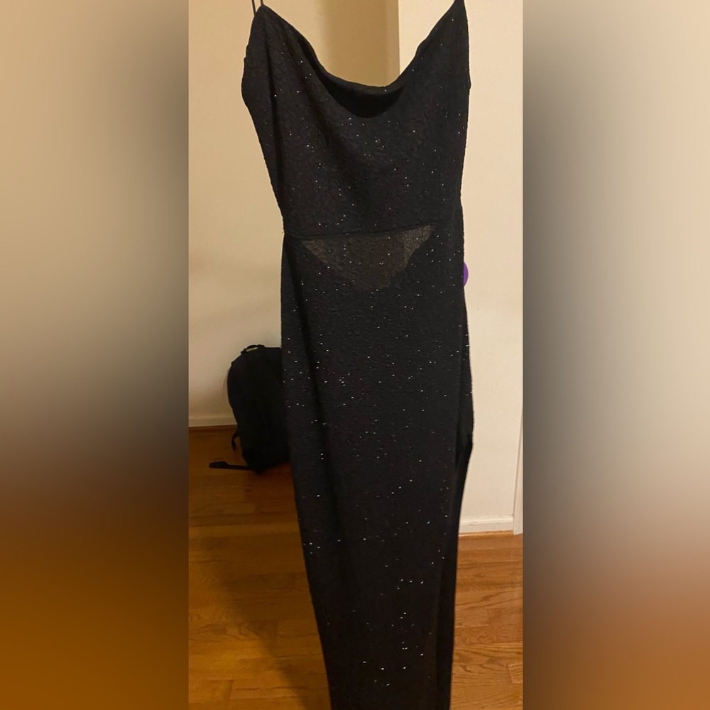 A black maxi dress with a slight slit on it
